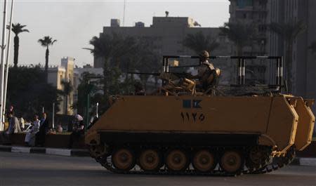 Egyptian army soldiers on an armoured personnel carrier (APC) take their position around Tahrir Square in Cairo, October 2, 2013, as members of the Muslim Brotherhood and supporters of ousted Egyptian president Mohamed Mursi planned another protest at the square. Egypt's army chief called on Tuesday for a quick transition to elections in order to restore stability to the country, while supporters of the Islamist president he ousted, Mohamed Mursi, staged daring protests urging an end to "military government". REUTERS/Amr Abdallah Dalsh