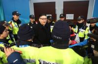 Ice Hockey – Pyeongchang 2018 Winter Olympics – Women Preliminary Round Match - Korea v Japan - Kwandong Hockey Centre, Gangneung, South Korea – February 14, 2018 - Kim Jong-un impersonator is surrounded by security personnel. REUTERS/Lucy Nicholson