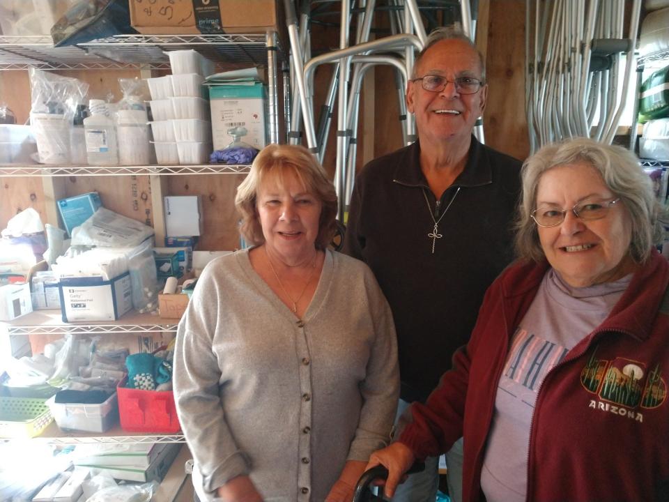 Charlene Katchuk, left; Jim Pierson, center; and Barb Quick, right; look over some medical equipment at The MED Shed in Nichols. The MED Shed collects medical equipment and supplies and gives it away to anyone who needs it.