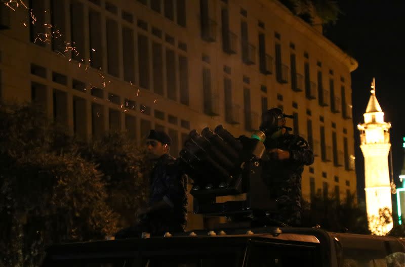 Riot police fire tear gas during anti government protests in Beirut