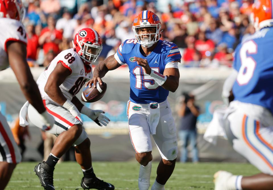 Oct 30, 2021; Jacksonville, Florida, USA; Florida Gators quarterback Anthony Richardson (15) runs out of the pocket with Georgia defensive tackle Jalen Carter in pursuit during the first half at TIAA Bank Field. Kim Klement-USA TODAY Sports