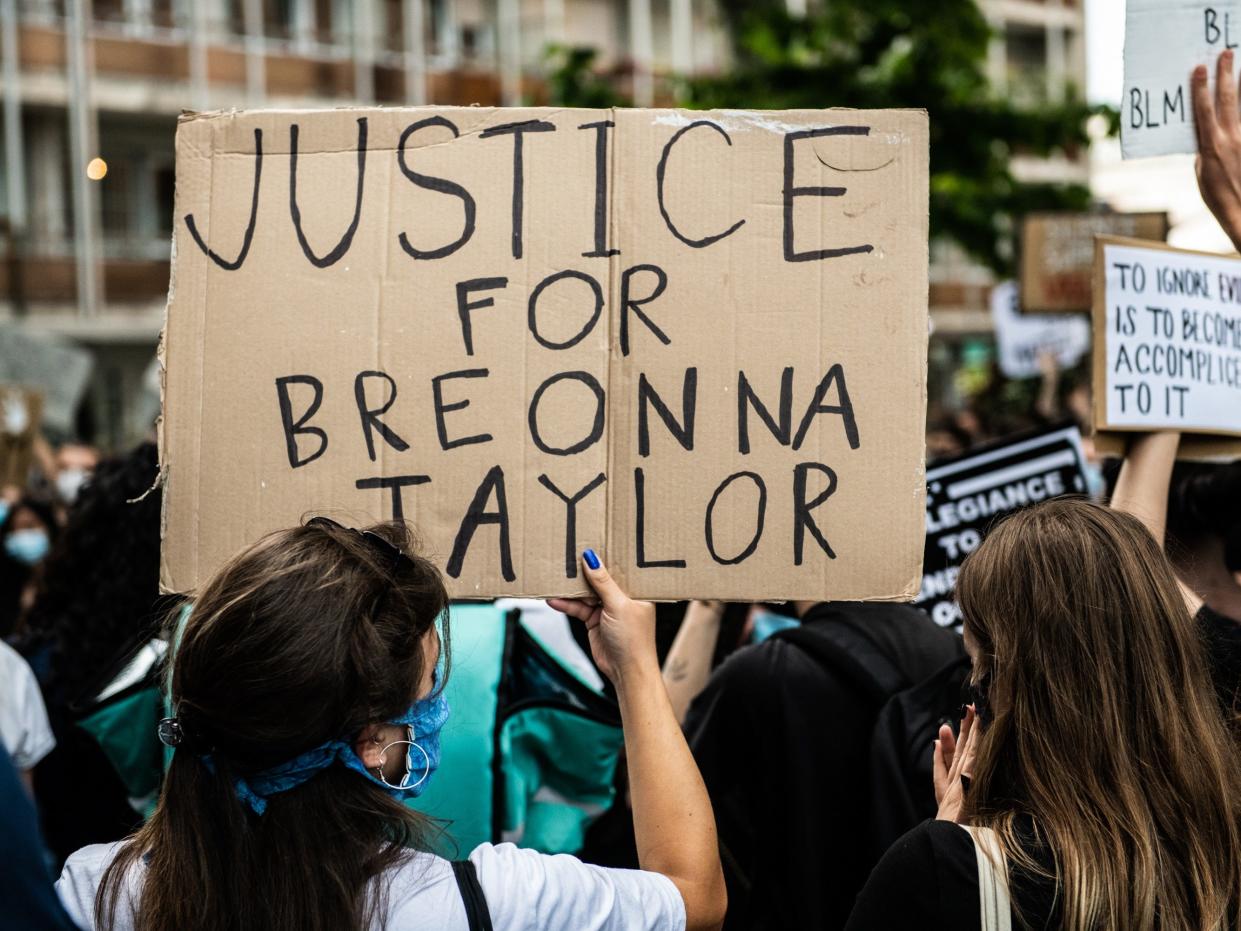 A girl holding a sign asking justice for Breonna Taylor demonstrating in Mestre, Venice, Italy on June 6, 2020