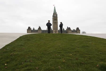 Royal Canadian Mounted Police officers stand guard on Parliament Hill in Ottawa October 23, 2014. REUTERS/Chris Wattie