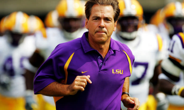 Nick Saban jogs onto the field before an LSU game.