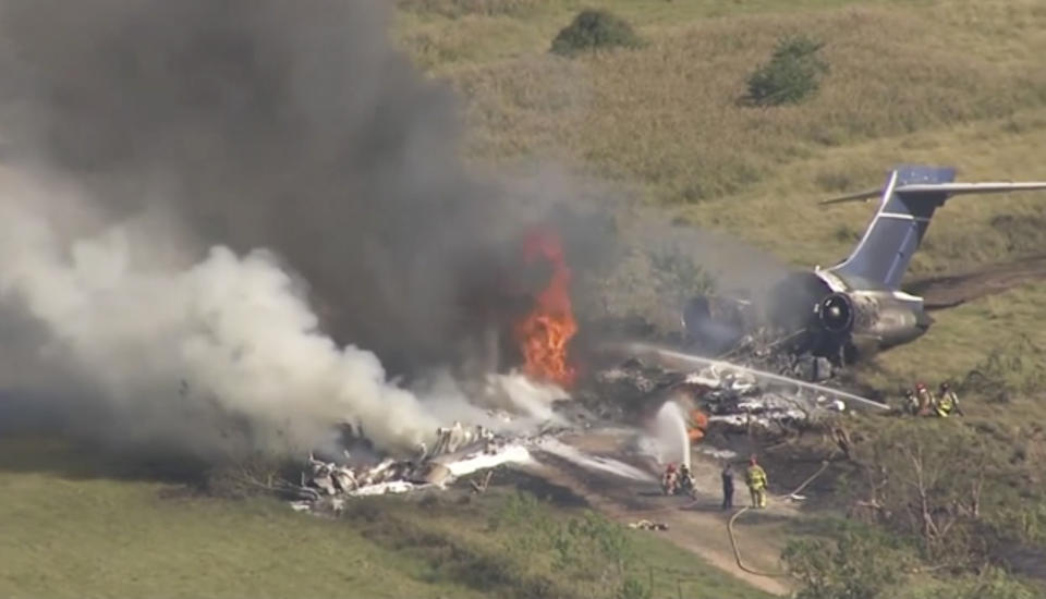 In this frame grab from video provided by KTRK, firefighters work the scene where a plane taking passengers from Texas to the AL Championship Series game in Boston burst into flames after it ran off a runway during takeoff Tuesday, Oct. 19, 2021, in Brookshire, Texas. No one was seriously hurt, authorities said. (KTRK via AP)