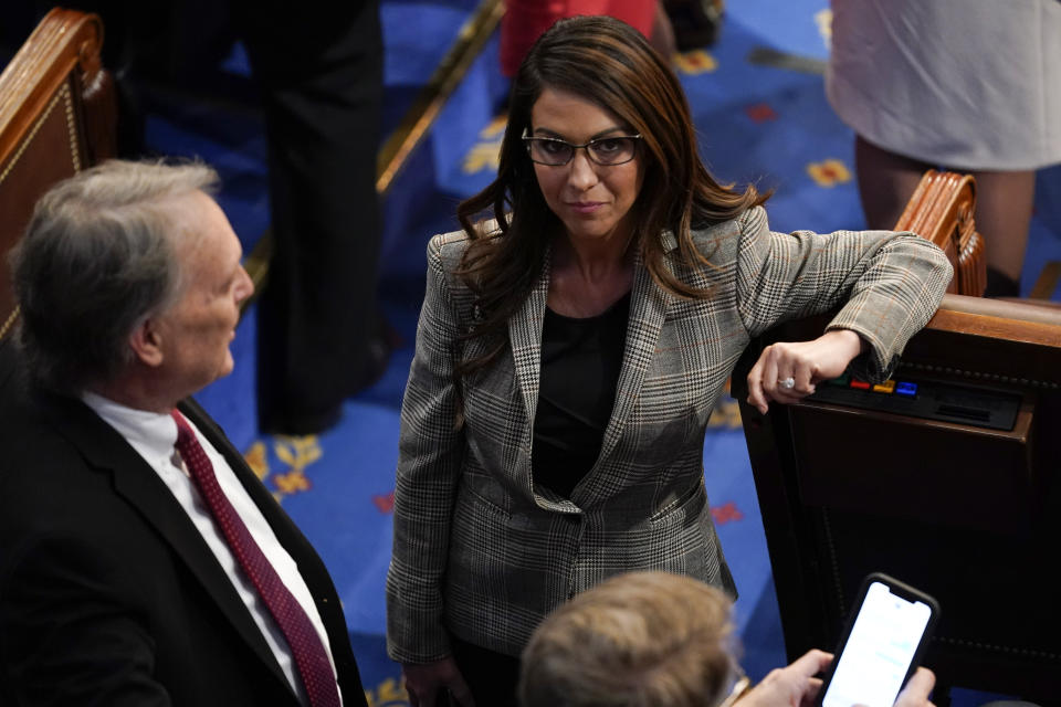 Rep. Lauren Boebert, R-Colo., talks with Rep. Andy Biggs, R-Ariz., after the 11th round of voting for speaker in the House chamber as the House meets for the third day to elect a speaker and convene the 118th Congress in Washington, Thursday, Jan. 5, 2023. (AP Photo/Andrew Harnik)