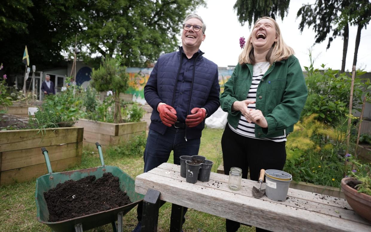 Labour Party leader Sir Keir Starmer potting plants with leader of Camden Council Georgia Gould during a visit to Harlesden Town Garden in north west London