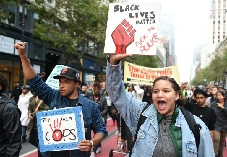 People march in solidarity along Market Street in San Francisco, California on July 8, 2016