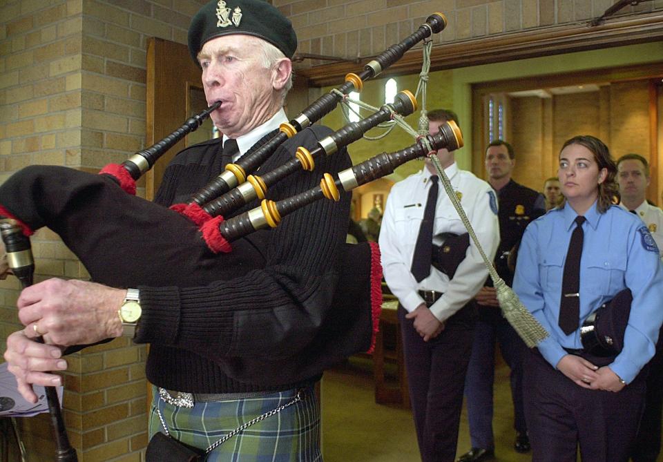 Terry Carroll leads police, firefighters and paramedics in 2002 out of the Church of the Ressurection Catholic Church in Lansing after the "Blue Mass" which commemorates the public service work they perform. Carroll died Feb. 20.