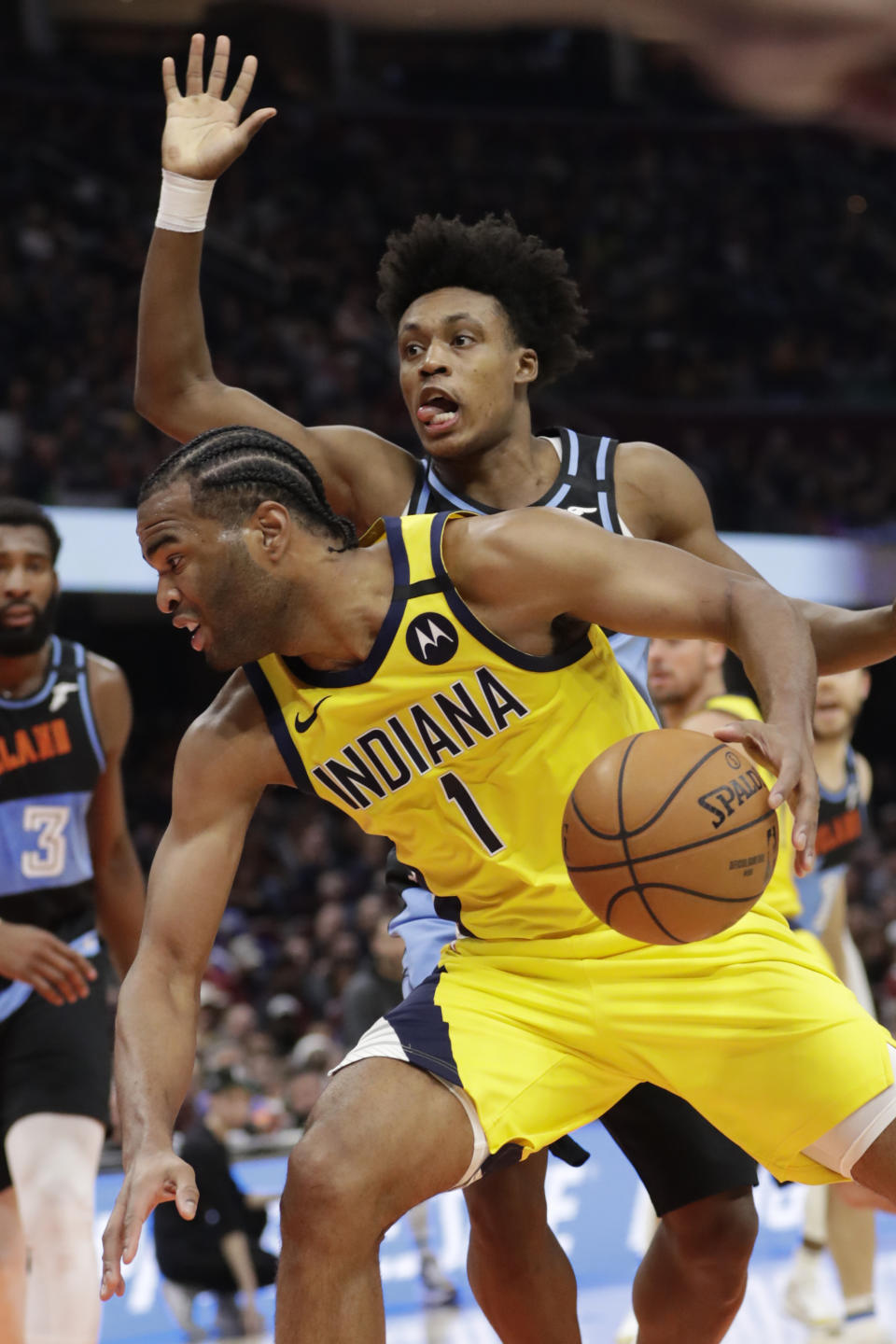 Indiana Pacers' T.J. Warren (1) drives past Cleveland Cavaliers' Collin Sexton (2) in the second half of an NBA basketball game, Saturday, Feb. 29, 2020, in Cleveland. Indiana won 113-104. (AP Photo/Tony Dejak)