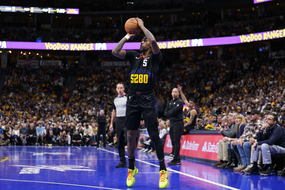 Denver Nuggets guard Kentavious Caldwell-Pope shoots a 3-point basket against the Los Angeles Clippers during the first half of an NBA basketball in-season tournament game Tuesday, Nov. 14, 2023, in Denver. (AP Photo/Jack Dempsey)