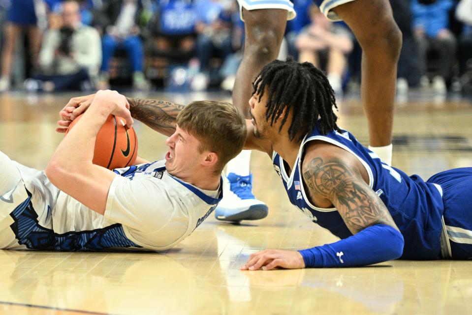 Feb 28, 2024; Omaha, Nebraska, USA; Seton Hall Pirates guard Dre Davis (14) and Creighton Bluejays guard Baylor Scheierman (55) reach for a loose ball in the first half at CHI Health Center Omaha. Mandatory Credit: Steven Branscombe-USA TODAY Sports