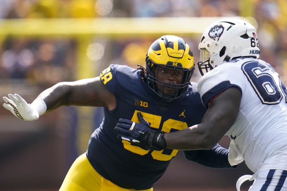 Michigan defensive lineman Mazi Smith (58) rushes against Connecticut offensive lineman Noel Ofori-Nyadu (62) in the first half of an NCAA college football game in Ann Arbor, Mich., Saturday, Sept. 17, 2022. (AP Photo/Paul Sancya)