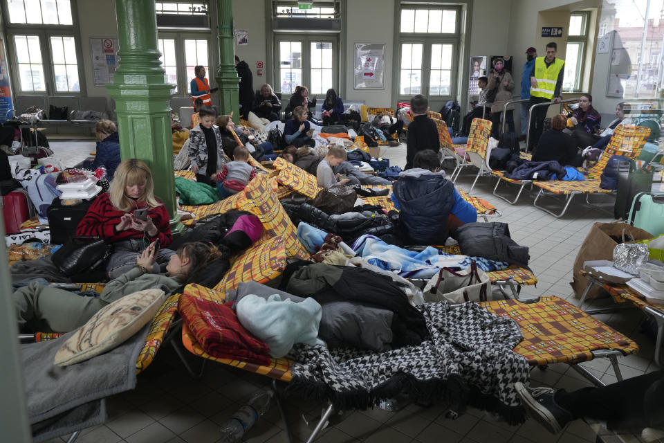 Refugees from Ukraine rest after arriving to the railway station in Przemysl, Poland, Sunday, Feb. 27, 2022. (Czarek Sokolowski/AP)