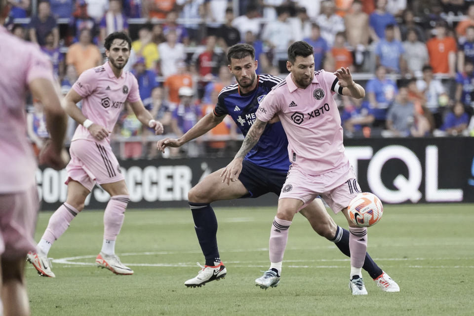 Inter Miami forward Lionel Messi, right, controls the ball next to FC Cincinnati defender Matt Miazga during the first half of a U.S. Open Cup soccer semifinal Wednesday, Aug. 23, 2023, in Cincinnati. (AP Photo/Joshua A. Bickel)