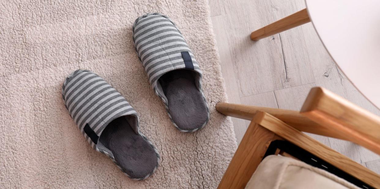 striped cotton slippers on floor next to table and chair