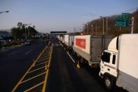 Trucks line up at a checkpoint leading to the Kaesong joint industrial zone, in Paju on February 11, 2016