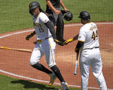 Pittsburgh Pirates' Oneil Cruz (15) is greeted by Rowdy Tellez (44) after scoring on a single by Connor Joe off Los Angeles Angels starting pitcher José Soriano during the fifth inning of a baseball game in Pittsburgh, Wednesday, May 8, 2024. (AP Photo/Gene J. Puskar)