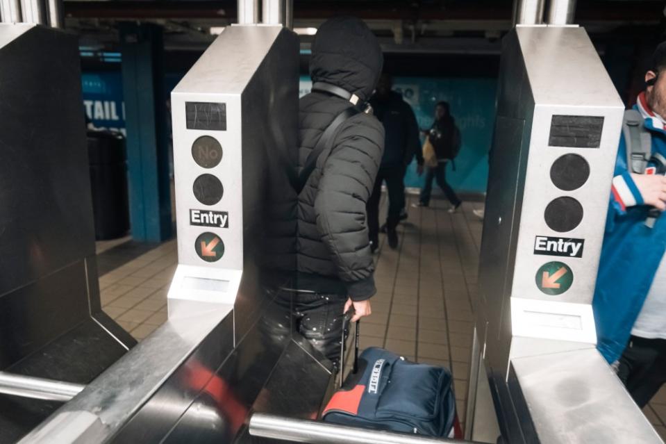 This man pushed his duffel bag under the turnstile and jumped over it himself. Stefano Giovannini