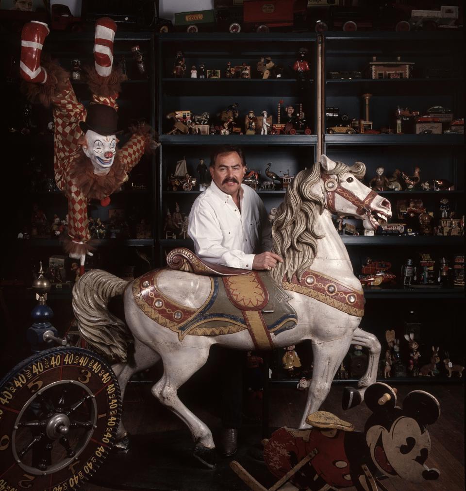 Joe Ley, owner of Joe Ley Antiques poses with a carousel horse in his shop. Feb. 20, 1993