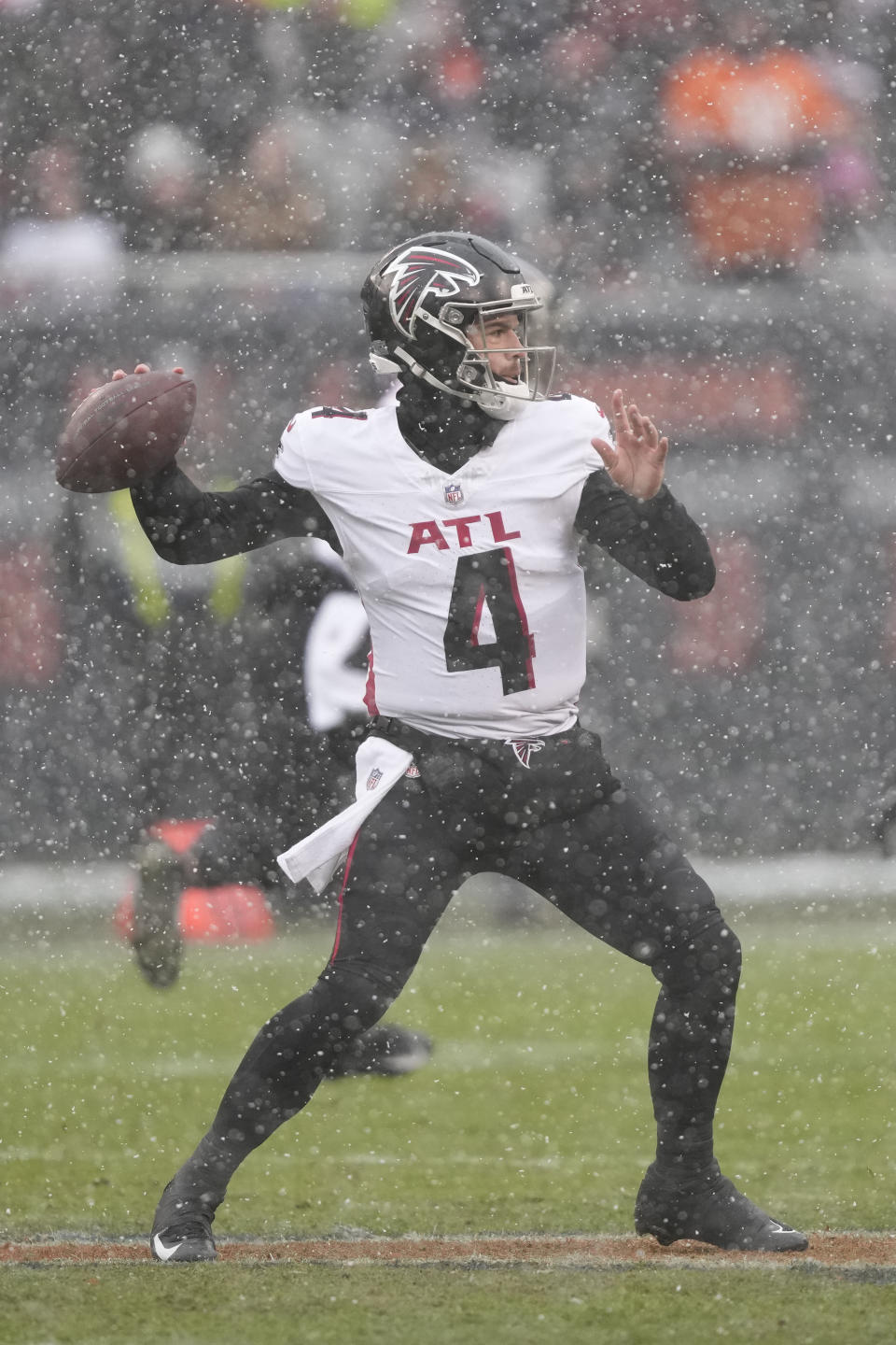 Atlanta Falcons quarterback Taylor Heinicke (4) sets back to pass in the first half of an NFL football game against the Chicago Bears in Chicago, Sunday, Dec. 31, 2023. (AP Photo/Charles Rex Arbogast)