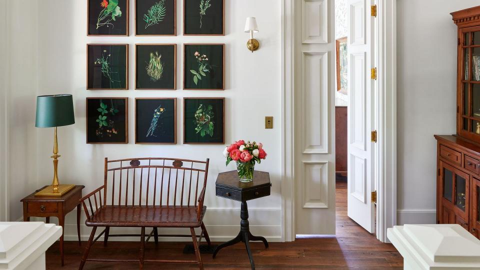 a room with a chair and a table with flowers on it