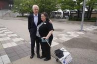 Roger Penske talks with Barbara Hellyer in the plaza before practice for the Indianapolis 500 auto race at Indianapolis Motor Speedway, Thursday, May 19, 2022, in Indianapolis. wld(AP Photo/Darron Cummings)