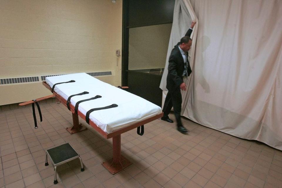 FILE â€“ In this November 2005 file photo, Larry Greene, public information director of the Southern Ohio Correctional Facility, demonstrates how a curtain is pulled between the death chamber and witness room at the prison in Lucasville, Ohio. The effectiveness of midazolam has been questioned following executions in Ohio, Arizona and, in April 27, 2017, Arkansas. Condemned inmate Kenneth Williams lurched and convulsed 20 times during a lethal injection execution that began with the controversial drug. (AP Photo/Kiichiro Sato, File)