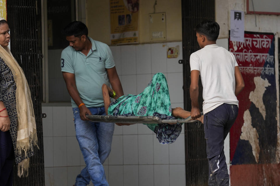 FILE - An elderly woman suffering from heat related ailment is brought to an overcrowded government district hospital in Ballia, Uttar Pradesh state, India, June 20, 2023. As temperatures and humidity soar outside, what's happening inside the human body can become a life-or-death battle decided by just a few degrees. (AP Photo/Rajesh Kumar Singh, File)