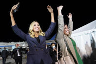 White House press secretary Kayleigh McEnany and White House legislative aide Cassidy Hutchinson dance to the song YMCA as President Donald Trump ends a campaign rally at Eugene F. Kranz Toledo Express Airport, Monday, Sept. 21, 2020, in Swanton, Ohio. (AP Photo/Alex Brandon)