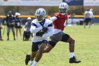 Dallas Cowboys running back Tony Pollard takes a handoff from quarterback Dak Prescott during the NFL football team's training camp in Oxnard, Calif., Thursday, July 22, 2021. (AP Photo/Michael Owen Baker)