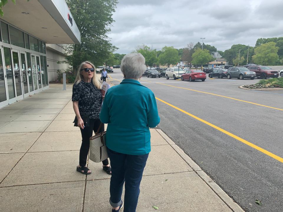 Union negotiating team member Anita Hovey talks to a Macy's customer at the Warwick Mall, asking her to support the union's position in negotiations.