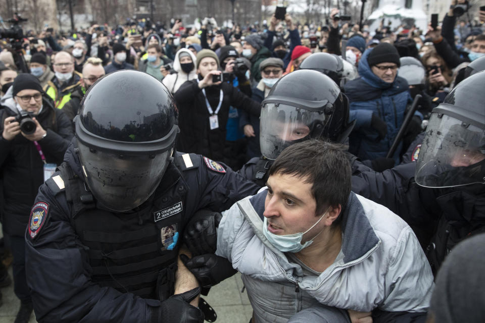 Police officers detain a man during a protest against the jailing of opposition leader Alexei Navalny in Moscow, Russia, Saturday, Jan. 23, 2021. Russian police on Saturday arrested hundreds of protesters who took to the streets in temperatures as low as minus-50 C (minus-58 F) to demand the release of Alexei Navalny, the country's top opposition figure. (AP Photo/Pavel Golovkin)