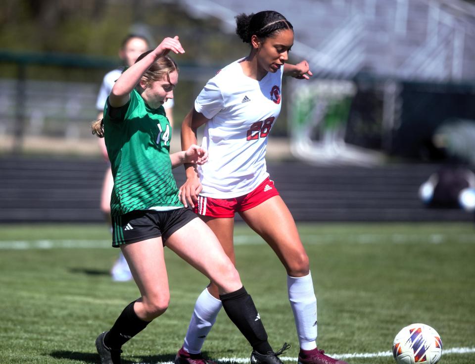 Springfield High's Kamryn Hoffman dribbles the ball Athens' Leilah Link during a nonconference girls soccer match on Saturday, April 6. The Senators won 7-0.