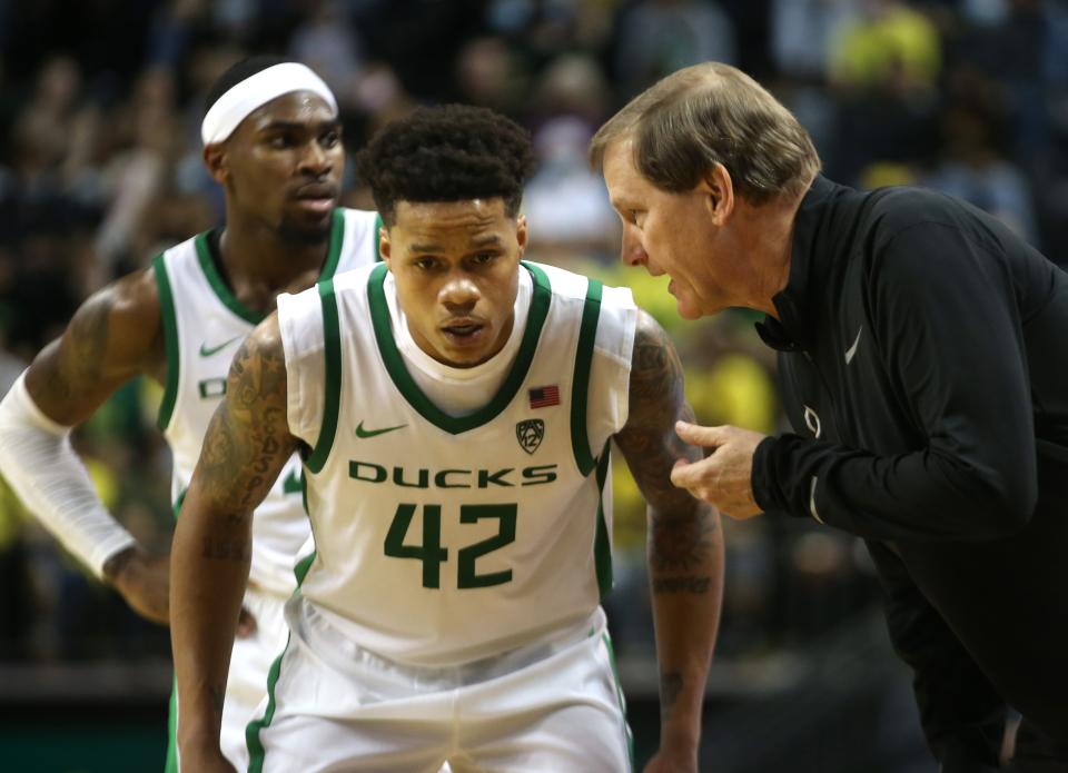 Oregon's Jacob Young, left, listens to instructions from coach Dana Altman during the second half against SMU earlier this season.