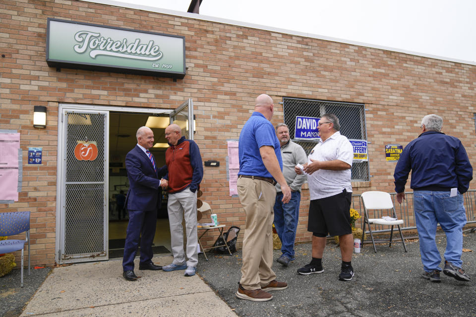 Daniel McCaffery, left, Democratic candidate for Pennsylvania Supreme Court judge, departs from his polling place after casting a ballot in Philadelphia, Tuesday, Nov. 7, 2023. (AP Photo/Matt Rourke)