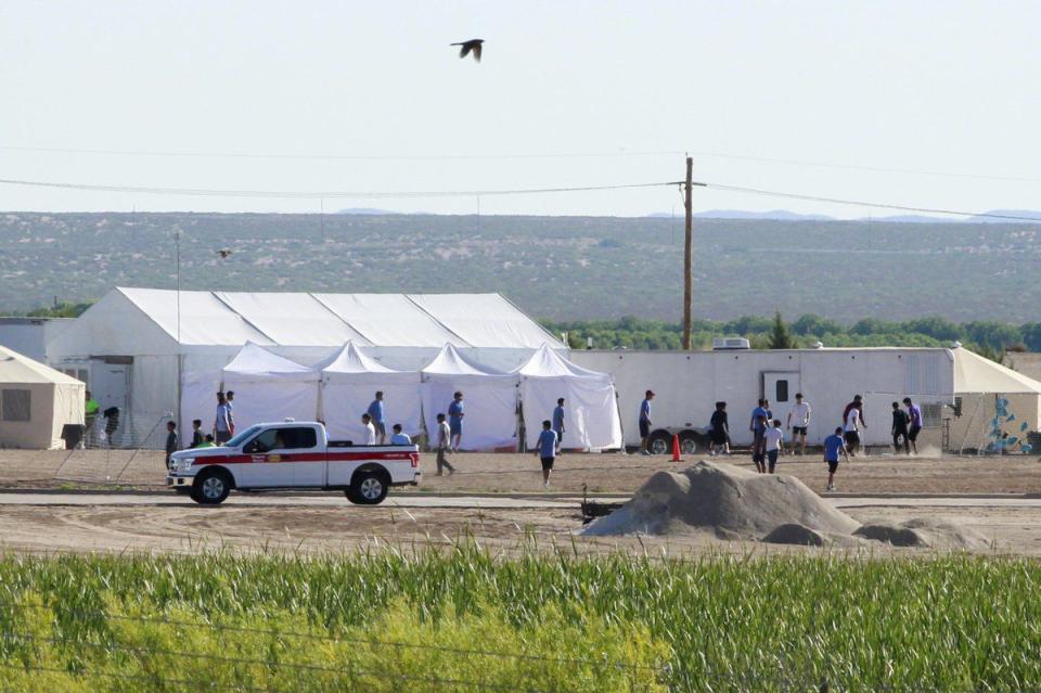 <p>Children of detained migrants play soccer at a newly constructed tent encampment as seen through a border fence near the U.S. Customs and Border Protection (CBP) port of entry in Tornillo, Texas, U.S. June 18, 2018.</p>