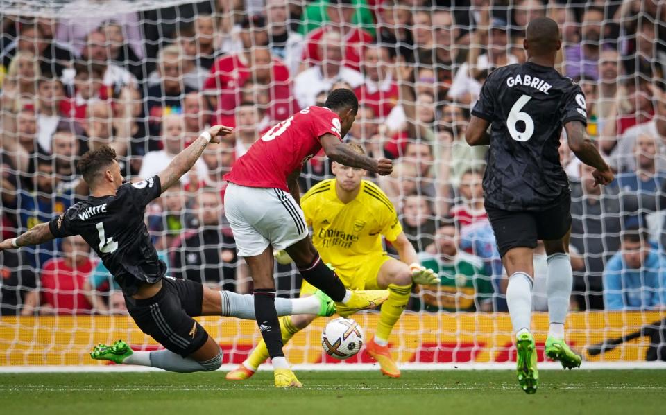 Manchester United's Marcus Rashford, centre, scores his side's second goal during the English Premier League soccer match between Manchester United and Arsenal at Old Trafford stadium, in Manchester, England, Sunday, Sept. 4, 2022. (AP Photo/Dave Thompson)