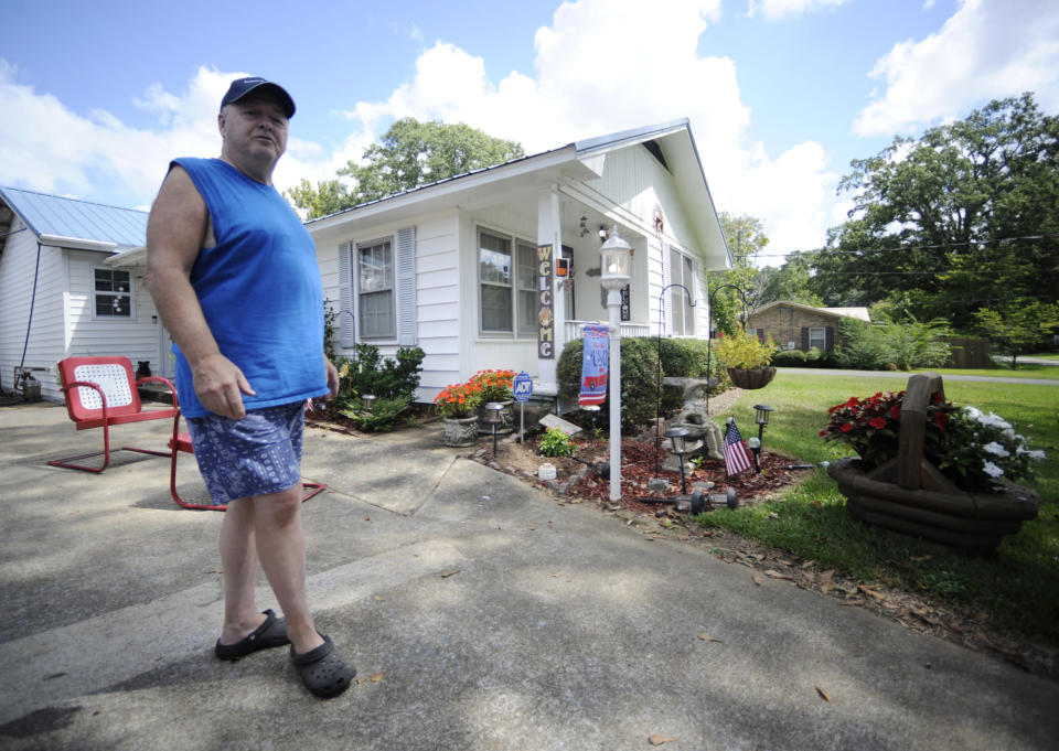 Roy Milam stands outside his home in Childersburg, Ala., on Monday, Aug. 29, 2022. Black pastor Michael Jennings was arrested at the house while watering flowers in May, and his attorney now plans a lawsuit over the incident. Milam said he feels bad over the way police treated Jennings. (AP Photo/Jay Reeves)