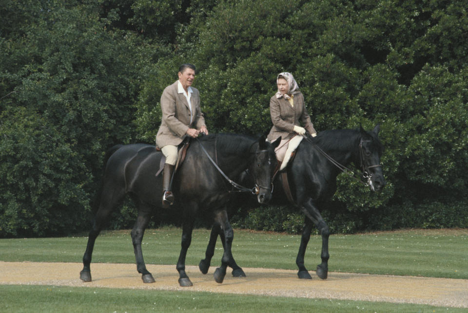 Queen Elizabeth II riding in the grounds of Windsor Castle with US President Ronald Reagan, during his state visit to the UK, 8th June 1982.
