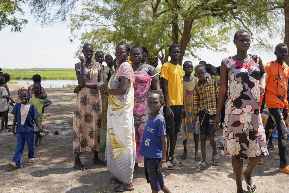 South-Sudanese who fled fighting in Sudan gather in Malakal town, which is hosting thousands who returned, in Upper Nile state, South Sudan Sunday, May 8, 2023. More than 40,000 people, mostly South Sudanese, have crossed the border into South Sudan since Sudan erupted in conflict nearly one month ago, yet many are returning to areas unable to support them and still riddled by fighting. (AP Photo/Sam Mednick)