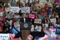 At the end of a stormy first month in office, President Donald Trump took to the road, revisiting the style and substance of the campaign trail at a rally in Florida