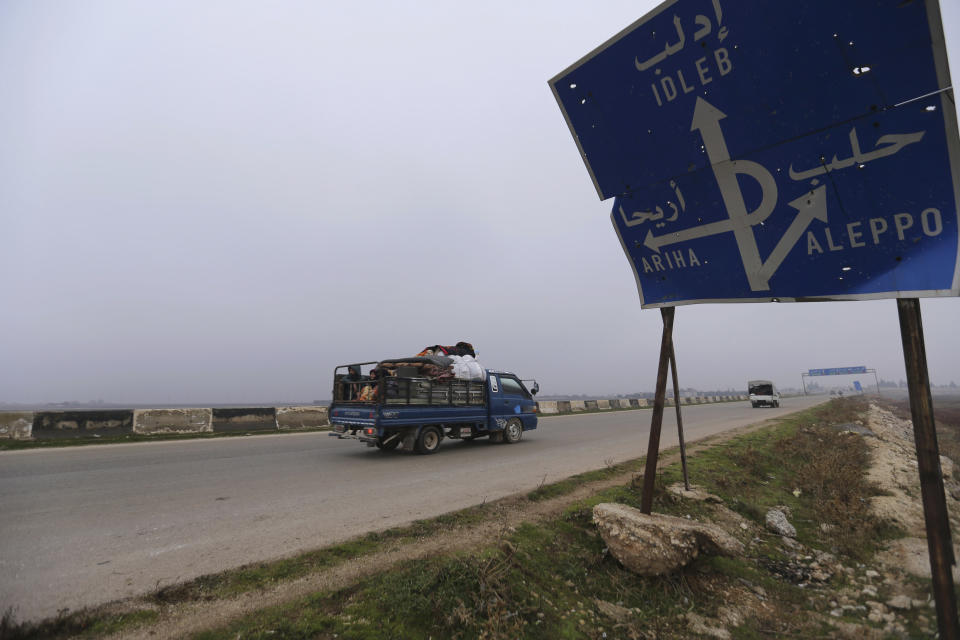 FILE - This Monday, Dec. 23, 2019, file photo, civilians ride in a truck as they flee Maaret al-Numan, Syria, ahead of a government offensive. The M5 highway, recaptured by President Bashar Assad’s forces this week, is arguably the most coveted prize in Syria’s civil war. The strategic highway is vital for Syria’s economy as well as for moving troops. (AP Photo/Ghaith Alsayed, File)