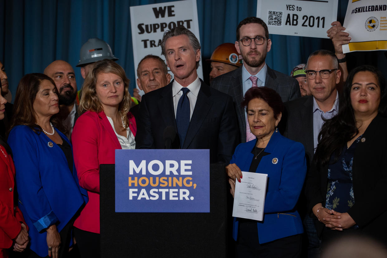 California Governor Gavin Newsom stands at a podium. 