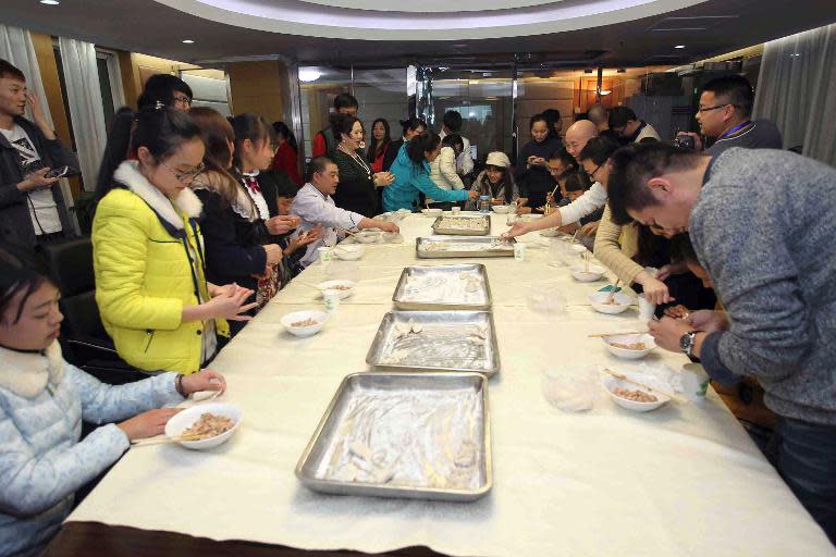 Migrant families gather to make dumplings as they prepare to celebrate the upcoming Lunar New Year, in Beijing, on January 28, 2014