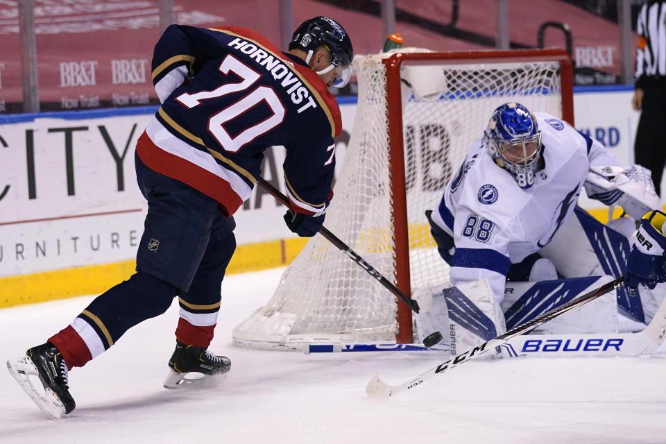 Florida Panthers right wing Patric Hornqvist (70) attempts a shot on the goal as Tampa Bay Lightning goaltender Andrei Vasilevskiy (88) defends during the second period of an NHL hockey game, Saturday, Feb. 13, 2021, in Sunrise, Fla. (AP Photo/Lynne Sladky)