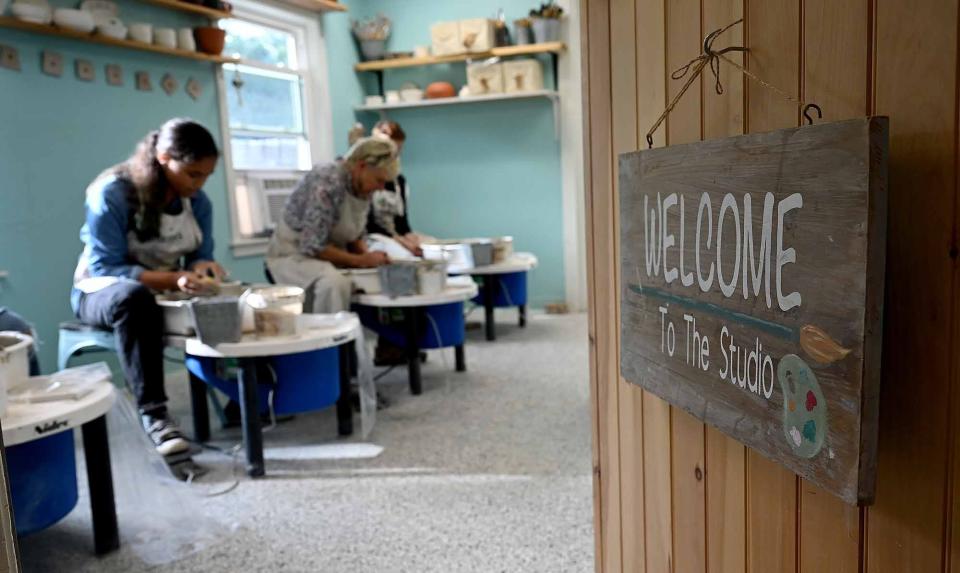 Students work on pottery wheels during a beginner class at ConnectEd & Inspired in Bellingham, Sept. 22, 2022.