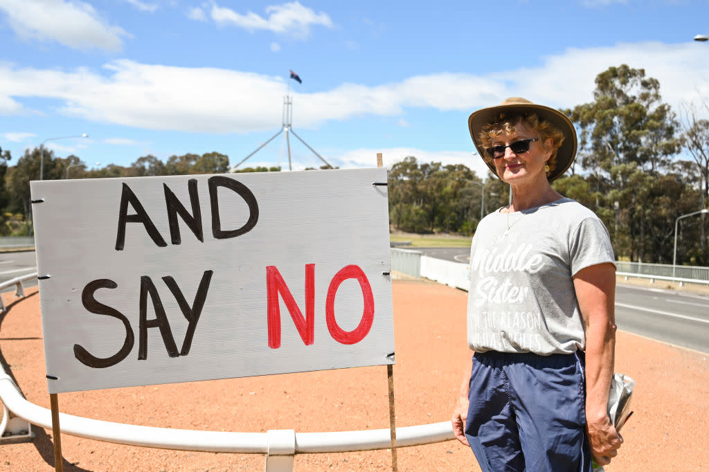 A campaigner against the referendum on establishing an Indigenous advisory group for the Australian Government erects signs in Canberra, the national capital. (Photo by Martin Ollman via Getty Images)