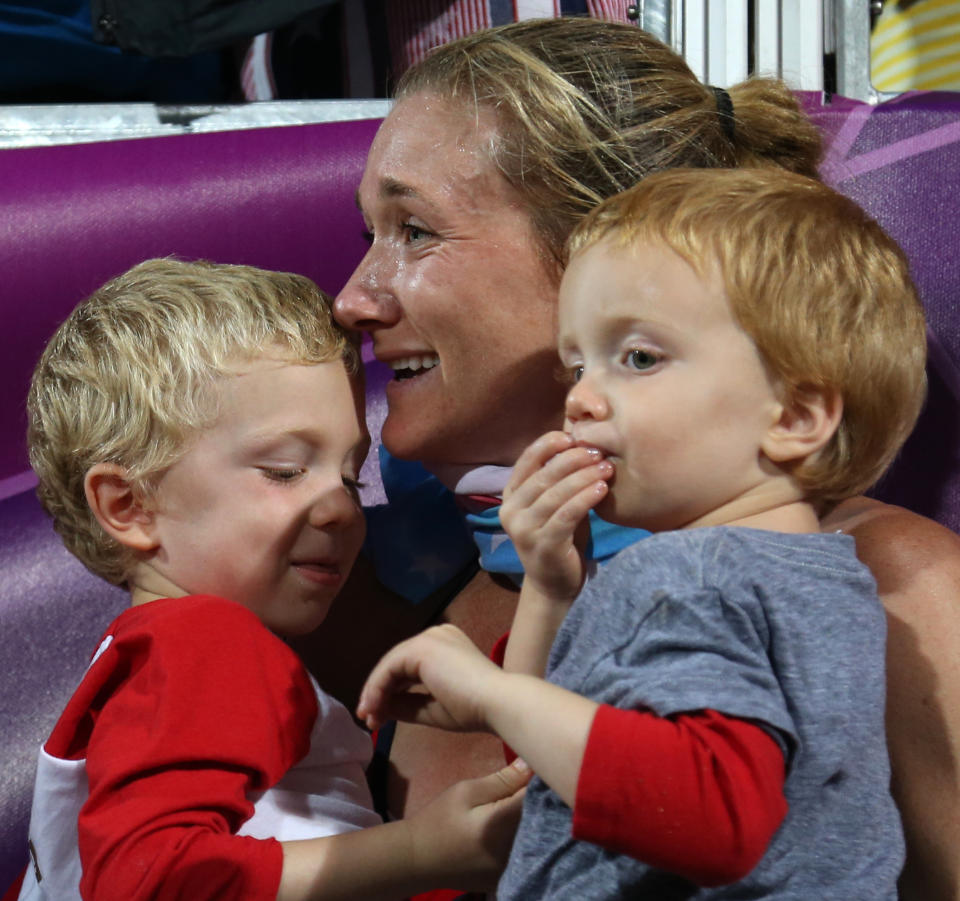 Kerri Walsh Jennings celebrates with her boys Joey and Sundance after winning the women’s gold medal beach volleyball match at the 2012 Summer Olympics. (AP)