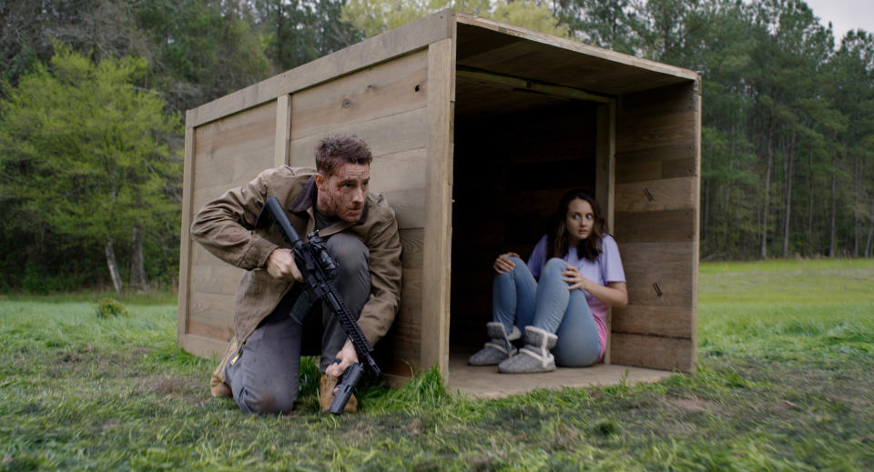 This image released by Universal Pictures shows Justin Hartley, left, and Sylvia Grace Crim in a scene from "The Hunt." (Universal Pictures via AP)